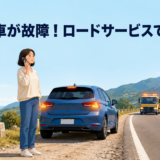 海外の道路で故障したレンタカーを安全な場所に止め、電話でロードサービスを呼ぶ日本人旅行者