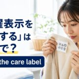 セーターの洗濯表示を確認する女性とcheck the care labelの英語表現
