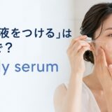 スポイト式美容液を顔につける女性とapply serumの英語表現