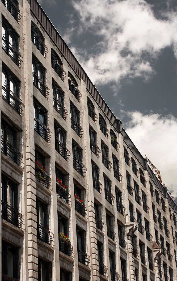 montreal_building_red_flowers_clouds.jpg